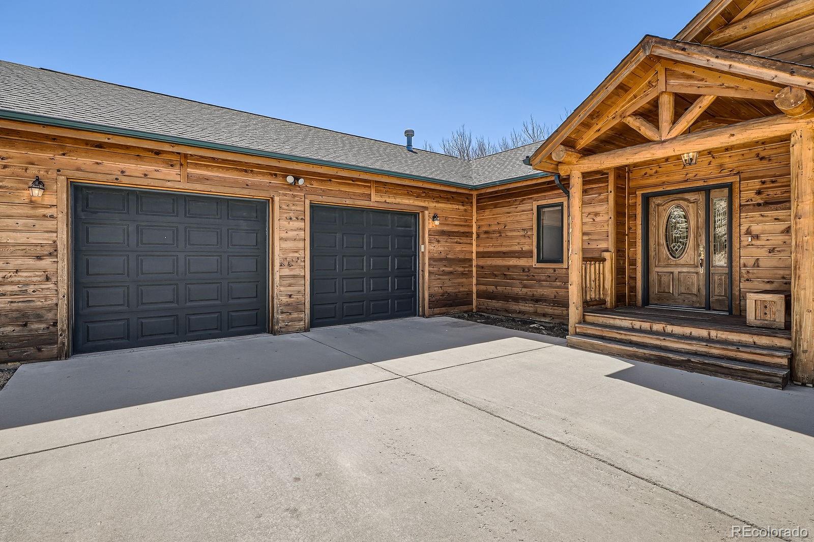 44 Forest Ridge Circle Bailey, CO 80421 - Photo 26 of 50 a front view of a house with a garage