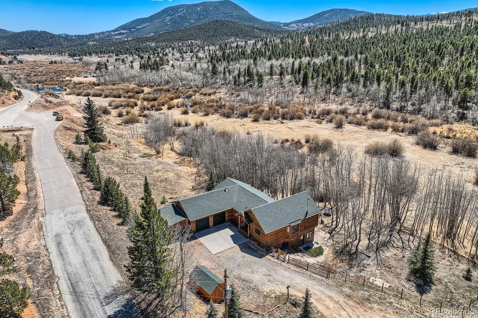 44 Forest Ridge Circle Bailey, CO 80421 - Photo 42 of 50 a view of a house with a yard and mountain view