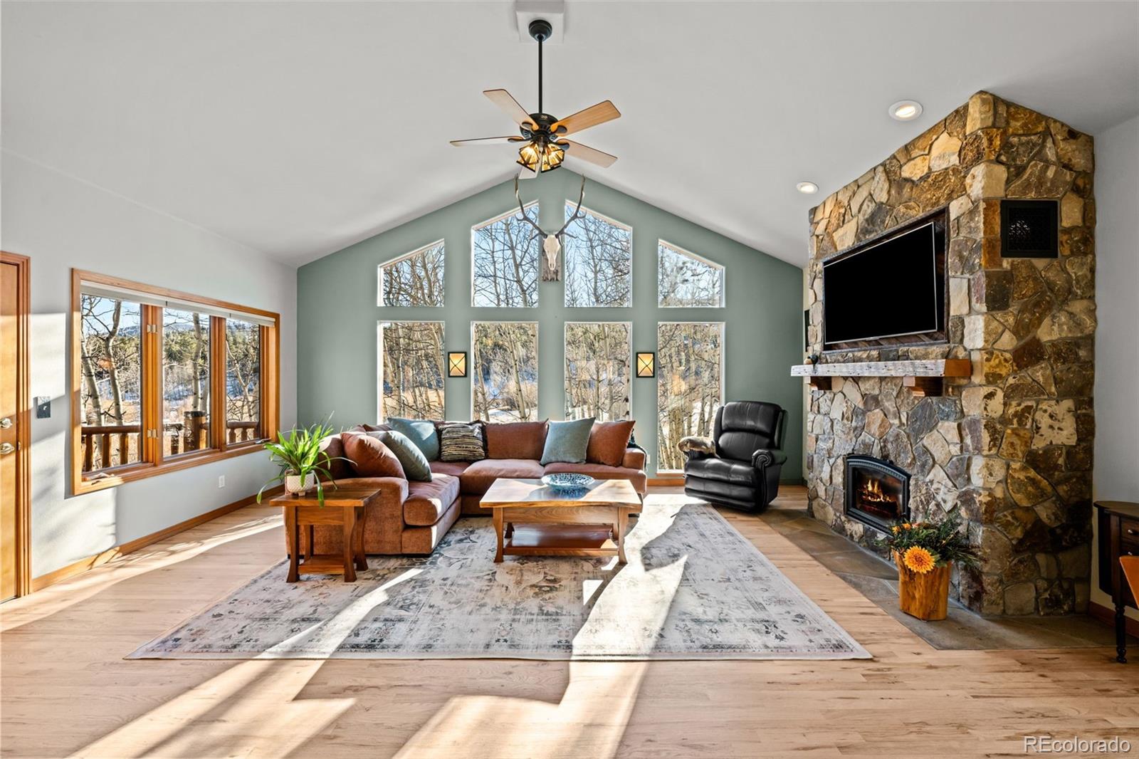 44 Forest Ridge Circle Bailey, CO 80421 - Photo 6 of 50 a living room with fireplace furniture and a flat screen tv