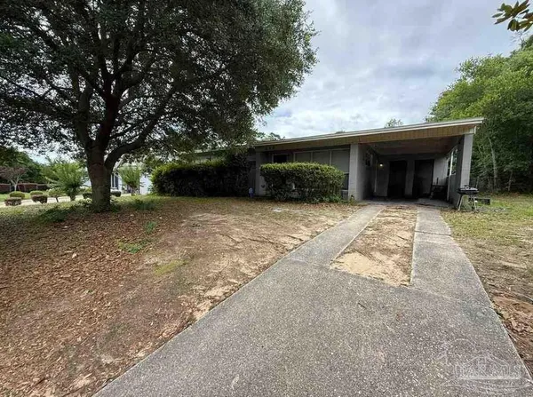 a front view of house with yard and trees