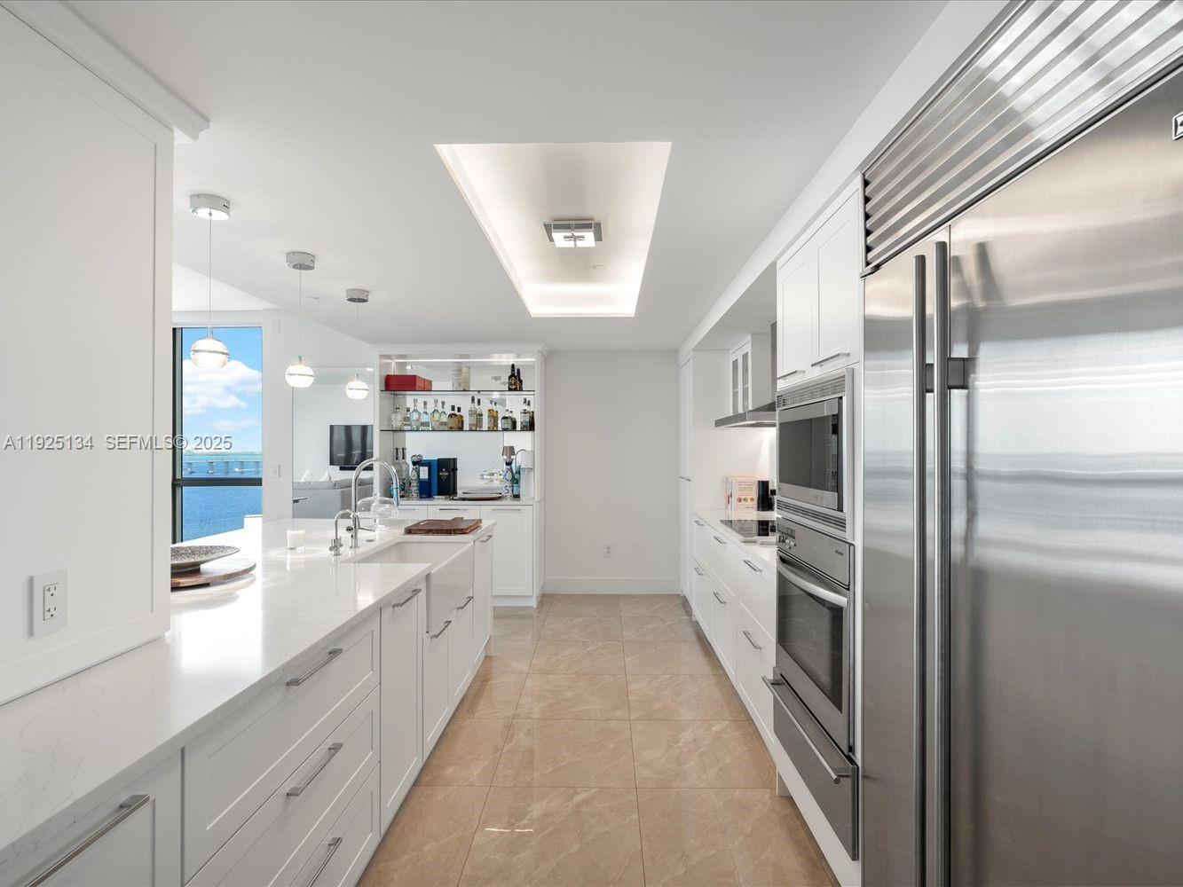 1331 Brickell Bay Drive, Unit 1811 Miami, FL 33131 - Photo 11 of 30 a large kitchen with a large counter top appliances and cabinets