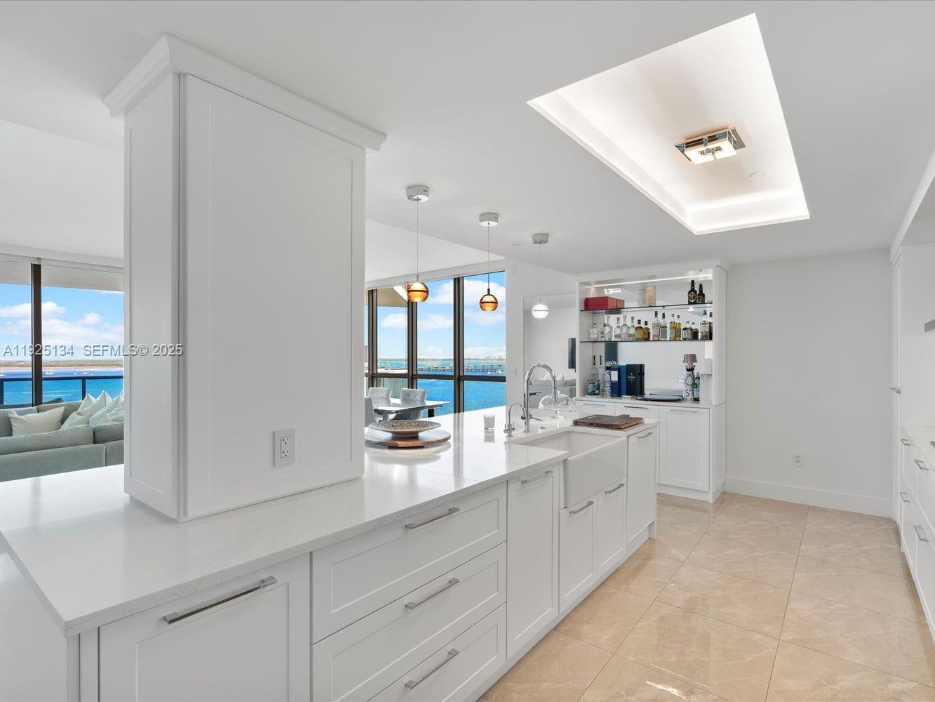 1331 Brickell Bay Drive, Unit 1811 Miami, FL 33131 - Photo 12 of 30 a large white kitchen with cabinets and window