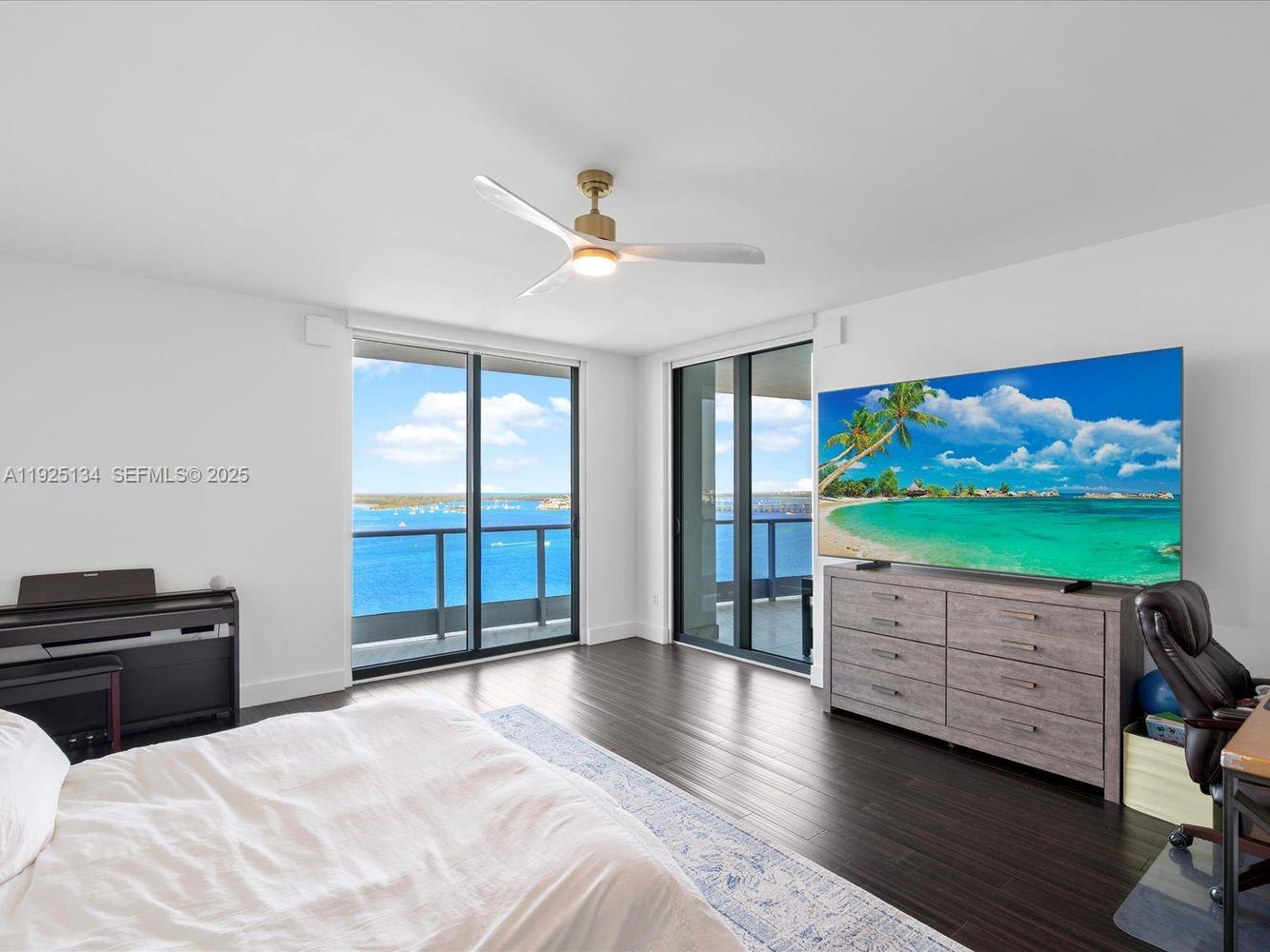 1331 Brickell Bay Drive, Unit 1811 Miami, FL 33131 - Photo 18 of 30 a bedroom with furniture and flat screen tv