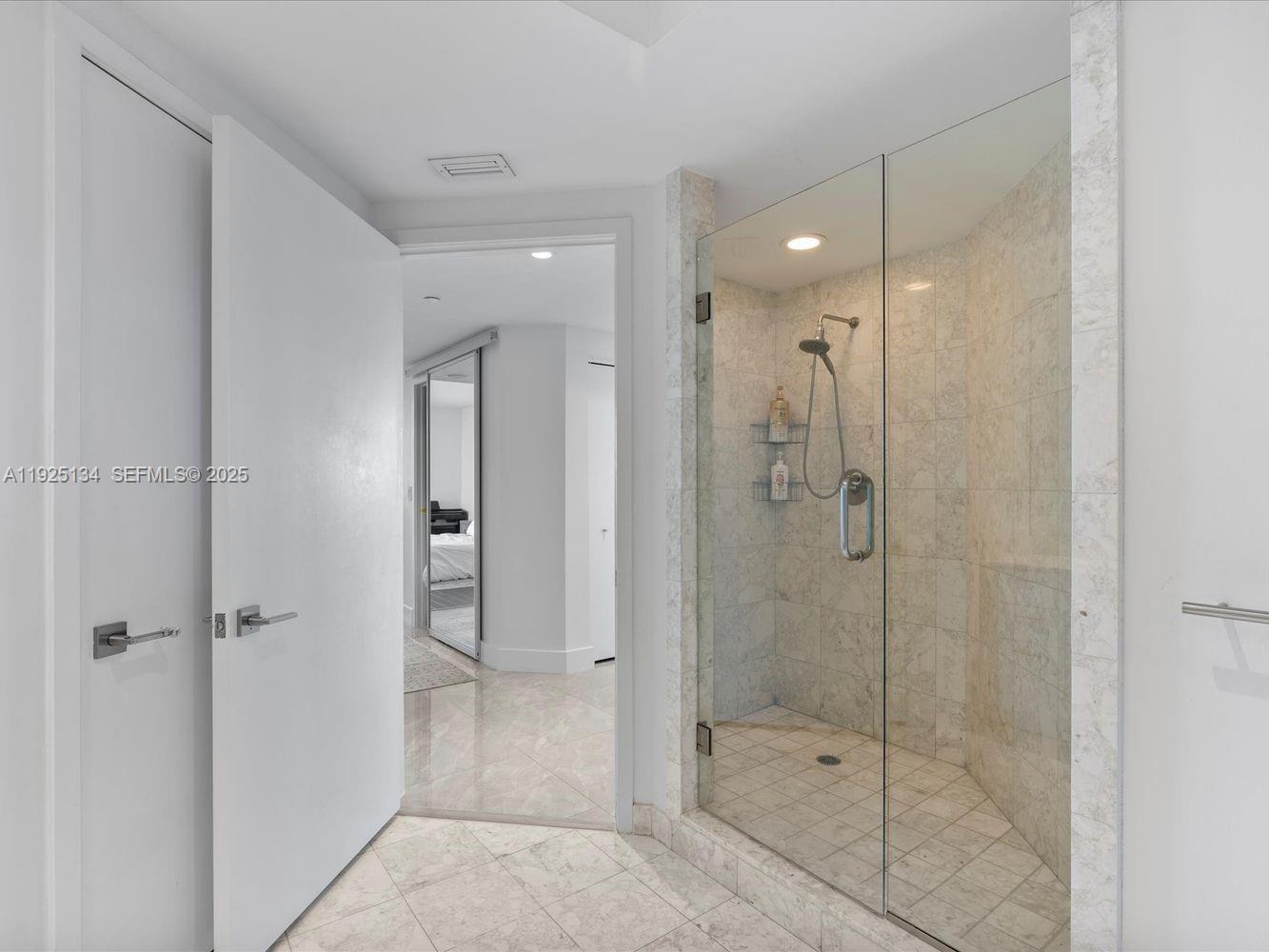 1331 Brickell Bay Drive, Unit 1811 Miami, FL 33131 - Photo 19 of 30 a bathroom with a shower and a glass door