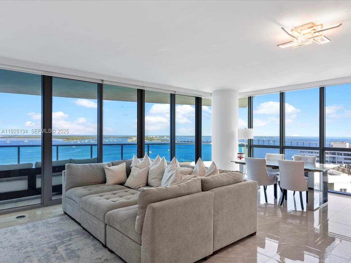 1331 Brickell Bay Drive, Unit 1811 Miami, FL 33131 - Photo 3 of 30 a living room with furniture and a large window
