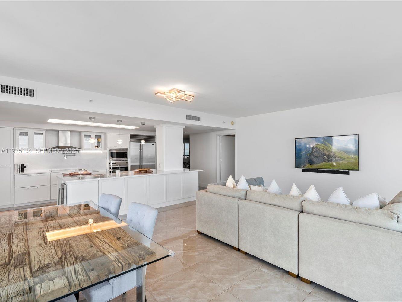 1331 Brickell Bay Drive, Unit 1811 Miami, FL 33131 - Photo 5 of 30 a living room with furniture and a flat screen tv