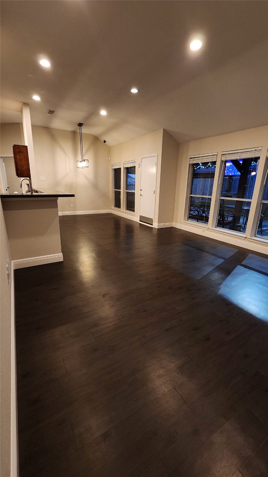 9310 Blackhawk Circle Houston, TX 77075 - Photo 11 of 23 an empty room with wooden floor and kitchen view