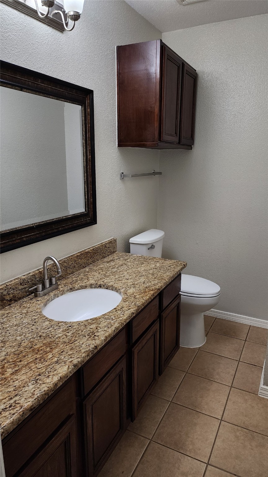 9310 Blackhawk Circle Houston, TX 77075 - Photo 17 of 23 a bathroom with a granite countertop sink a mirror and toilet