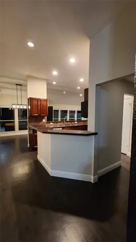 a kitchen with stainless steel appliances a refrigerator and a stove top oven