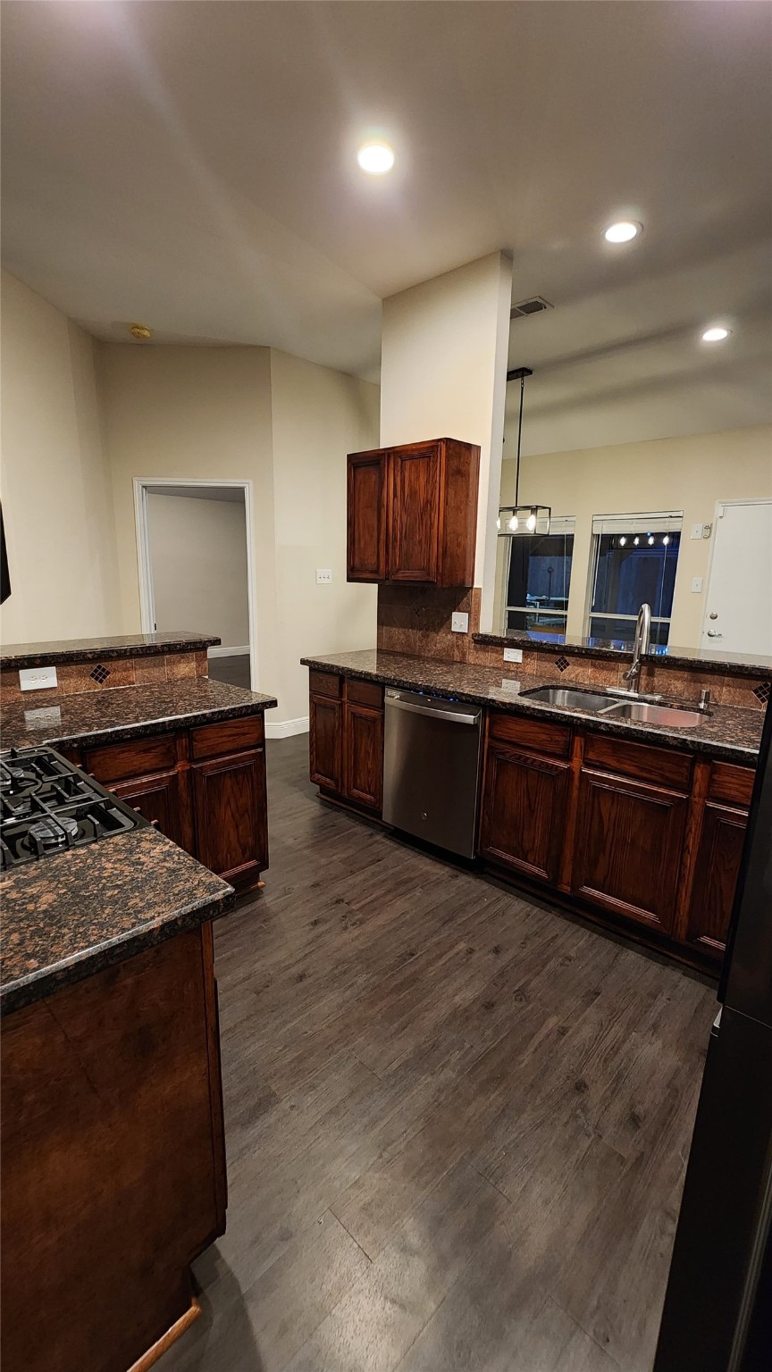 9310 Blackhawk Circle Houston, TX 77075 - Photo 6 of 23 a kitchen with stainless steel appliances granite countertop a stove top oven a sink dishwasher a microwave oven and a refrigerator
