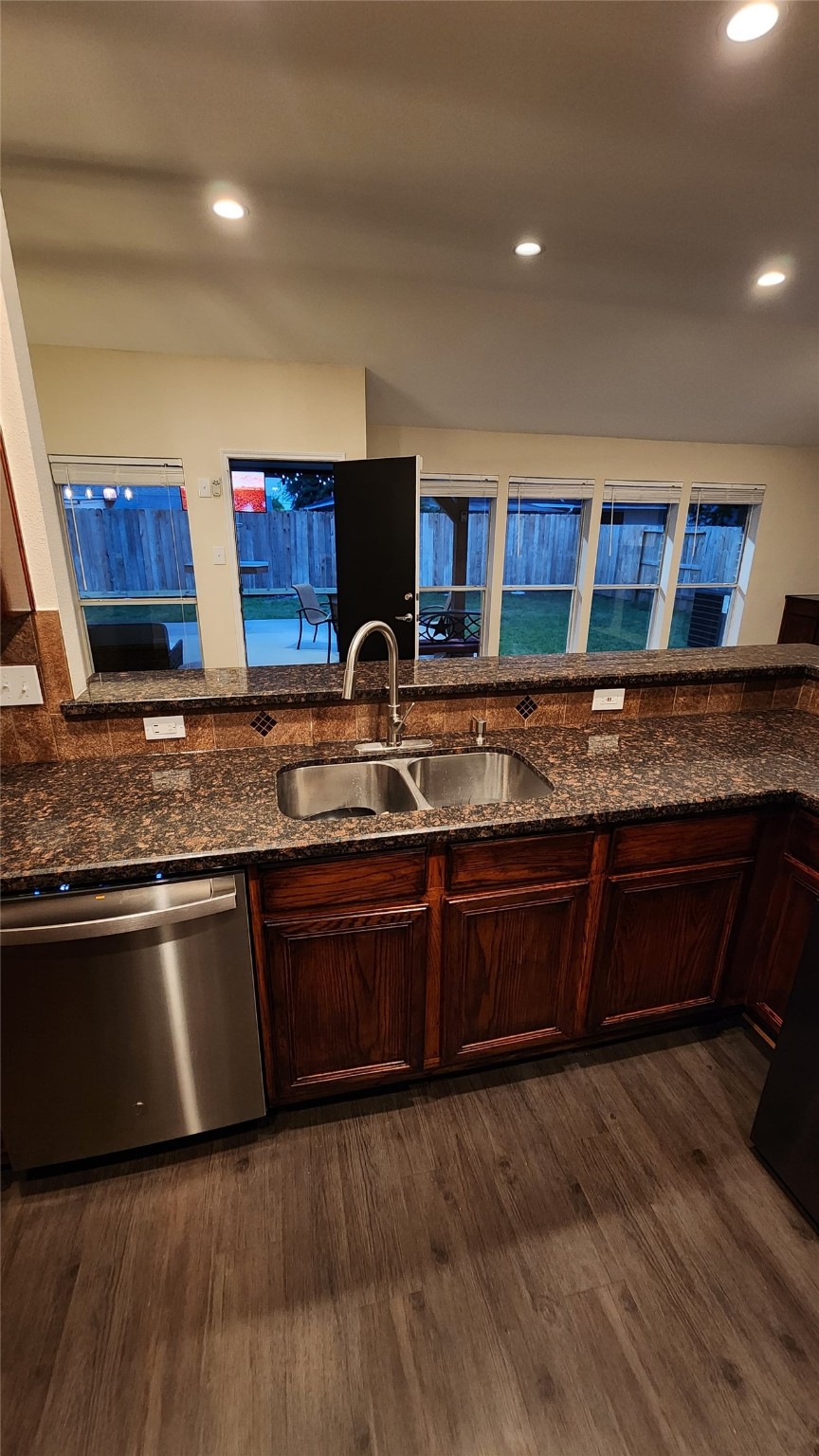 9310 Blackhawk Circle Houston, TX 77075 - Photo 8 of 23 a kitchen with stainless steel appliances granite countertop wooden cabinets a stove top oven a sink and dishwasher