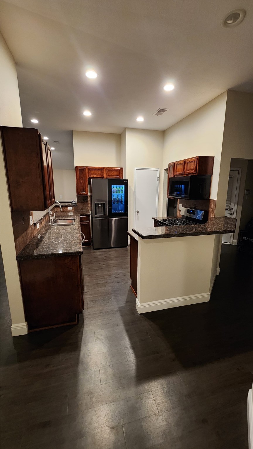 9310 Blackhawk Circle Houston, TX 77075 - Photo 9 of 23 a kitchen with stainless steel appliances kitchen island granite countertop a stove a refrigerator a sink and a microwave
