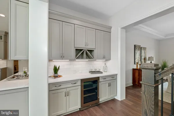 a kitchen with a sink cabinets and wooden floor