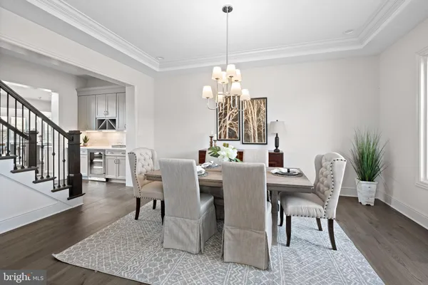 a view of a dining room with furniture wooden floor and chandelier