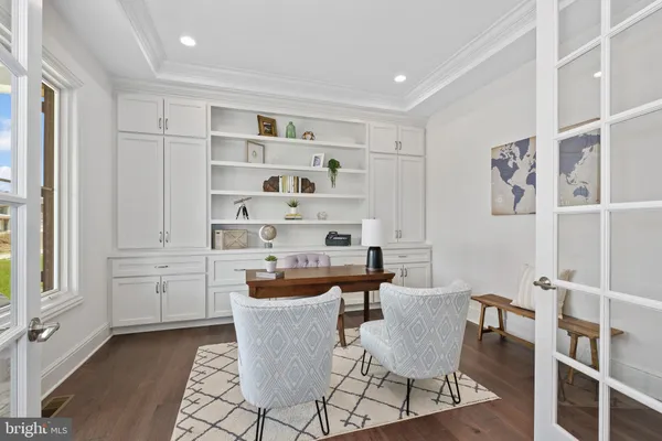 a dining room with wooden floor and windows