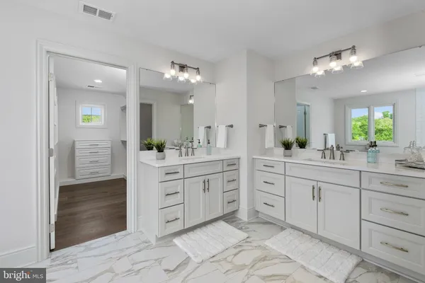 a spacious bathroom with a granite countertop sink mirror and a