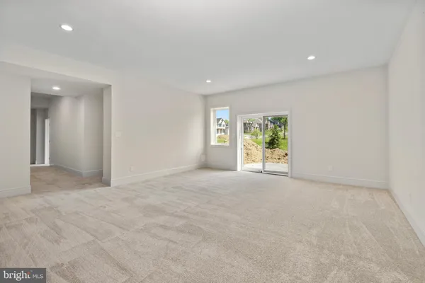 a view of a livingroom with an empty space and a window