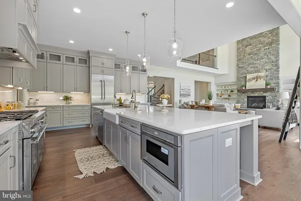 a kitchen with a sink stove and cabinets