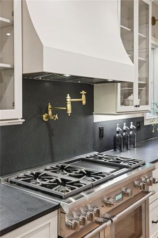 a stove top oven sitting inside of a kitchen