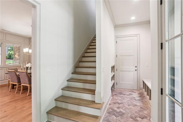 a view of entryway and hall with wooden floor