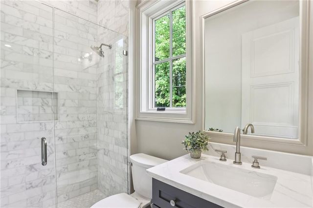 a bathroom with a sink toilet and shower