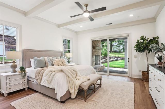 a bedroom with a large bed and a flat tv screen