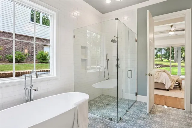 a spacious bathroom with a shower and a sink