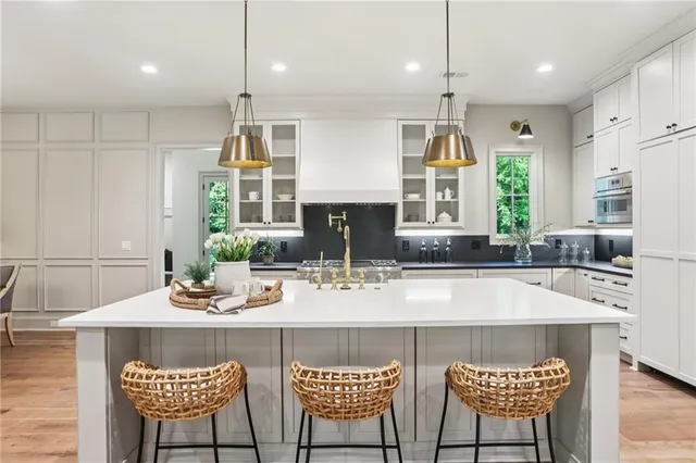 a kitchen with stainless steel appliances granite countertop a stove a sink and a refrigerator