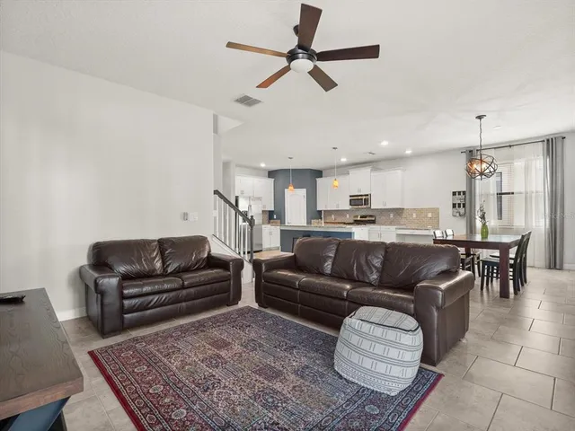 a living room with furniture or kitchen view and a chandelier
