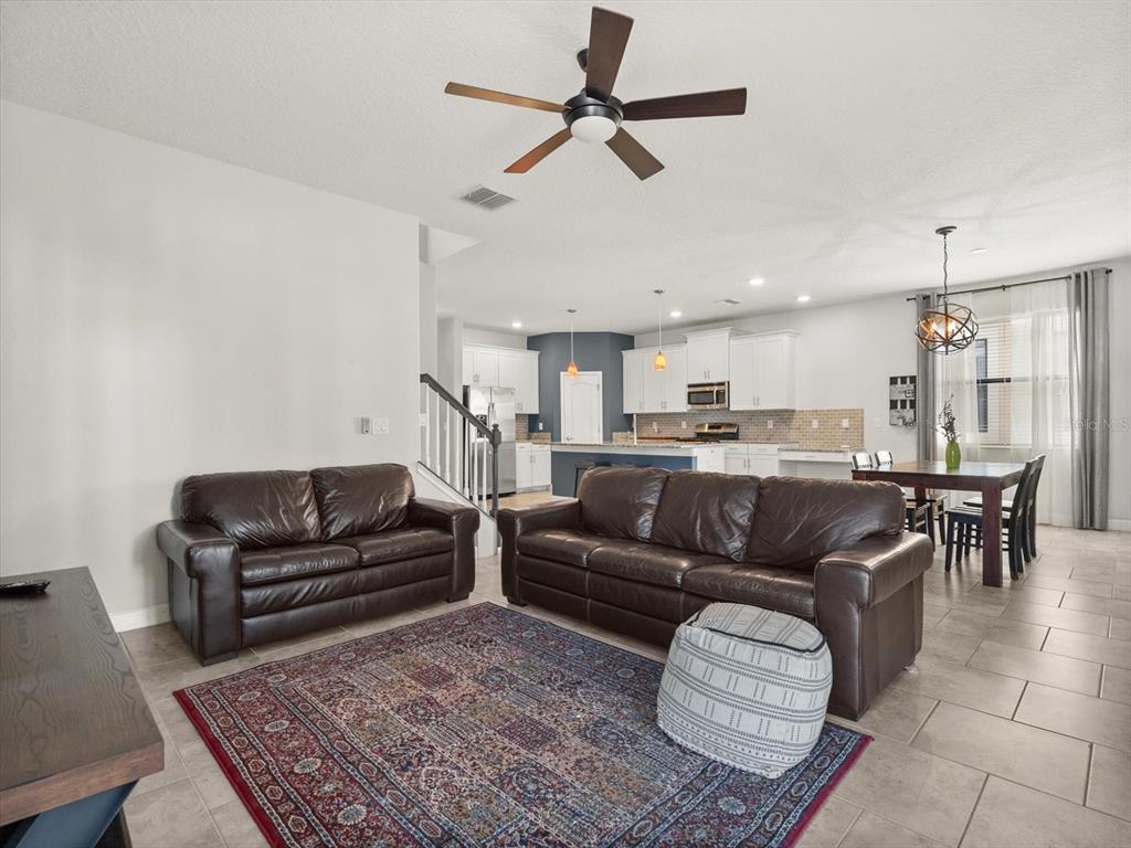 15433 Porter Road Winter Garden, FL 34787 - Photo 13 of 46 a living room with furniture or kitchen view and a chandelier