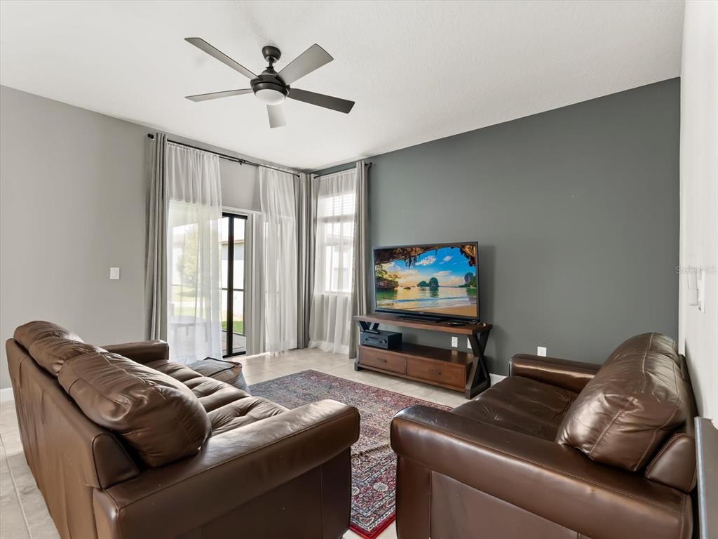 15433 Porter Road Winter Garden, FL 34787 - Photo 22 of 46 a living room with furniture and a flat screen tv