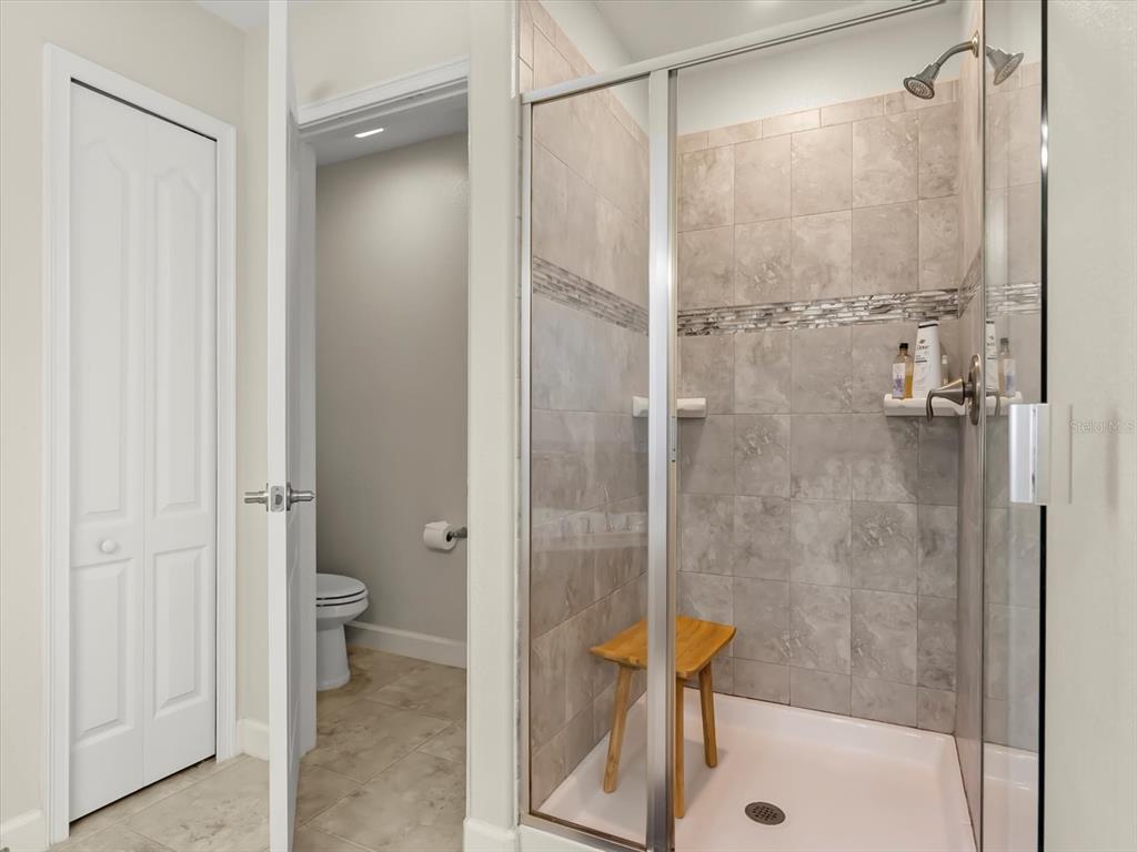 15433 Porter Road Winter Garden, FL 34787 - Photo 26 of 46 a bathroom with a shower and a glass door shower