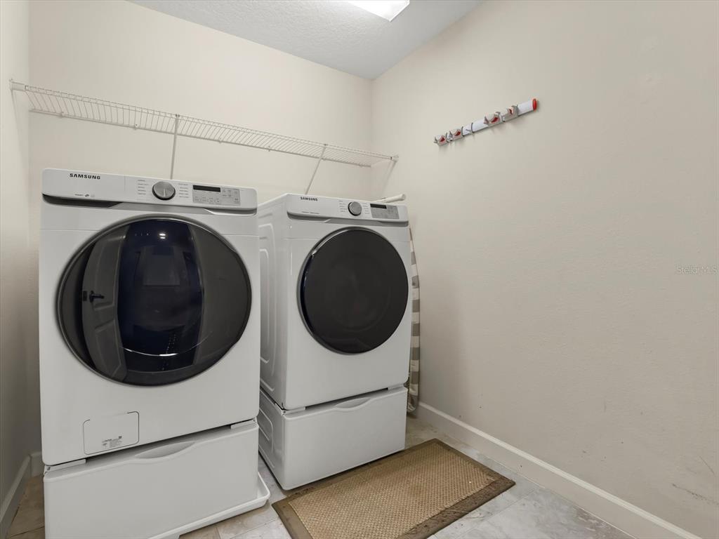 15433 Porter Road Winter Garden, FL 34787 - Photo 28 of 46 a utility room with dryer and washer