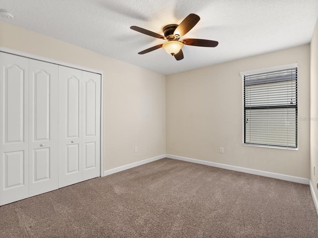 15433 Porter Road Winter Garden, FL 34787 - Photo 29 of 46 an empty room with windows and fan