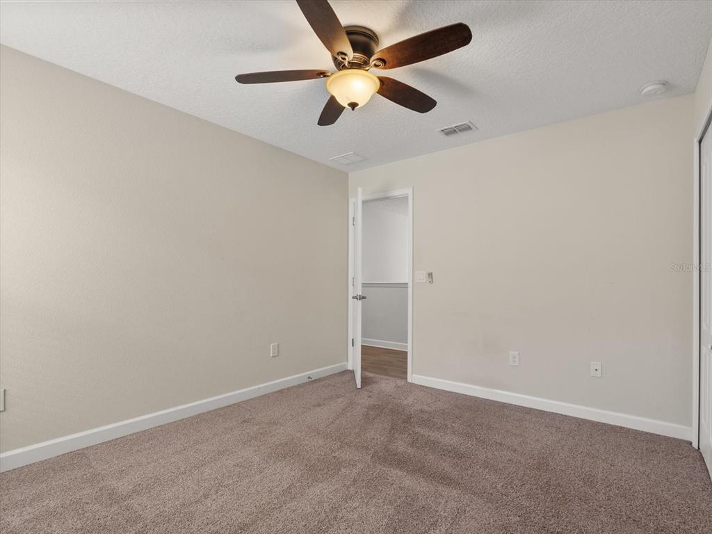 15433 Porter Road Winter Garden, FL 34787 - Photo 30 of 46 an empty room with a ceiling fan and a fan