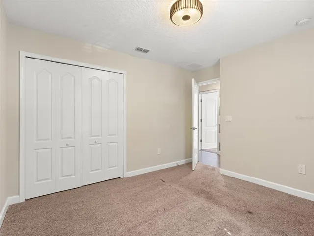 an empty room with closet area