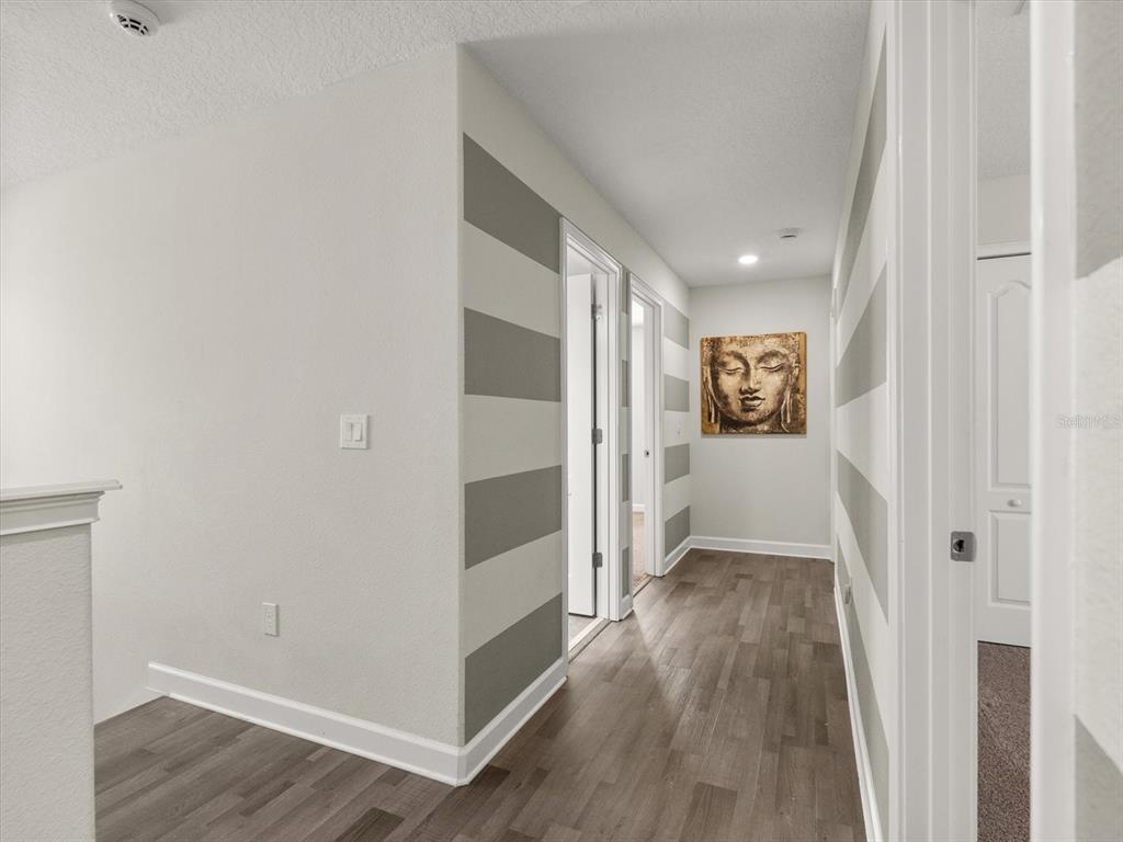 15433 Porter Road Winter Garden, FL 34787 - Photo 36 of 46 a view of a hallway with wooden floor and a bathroom