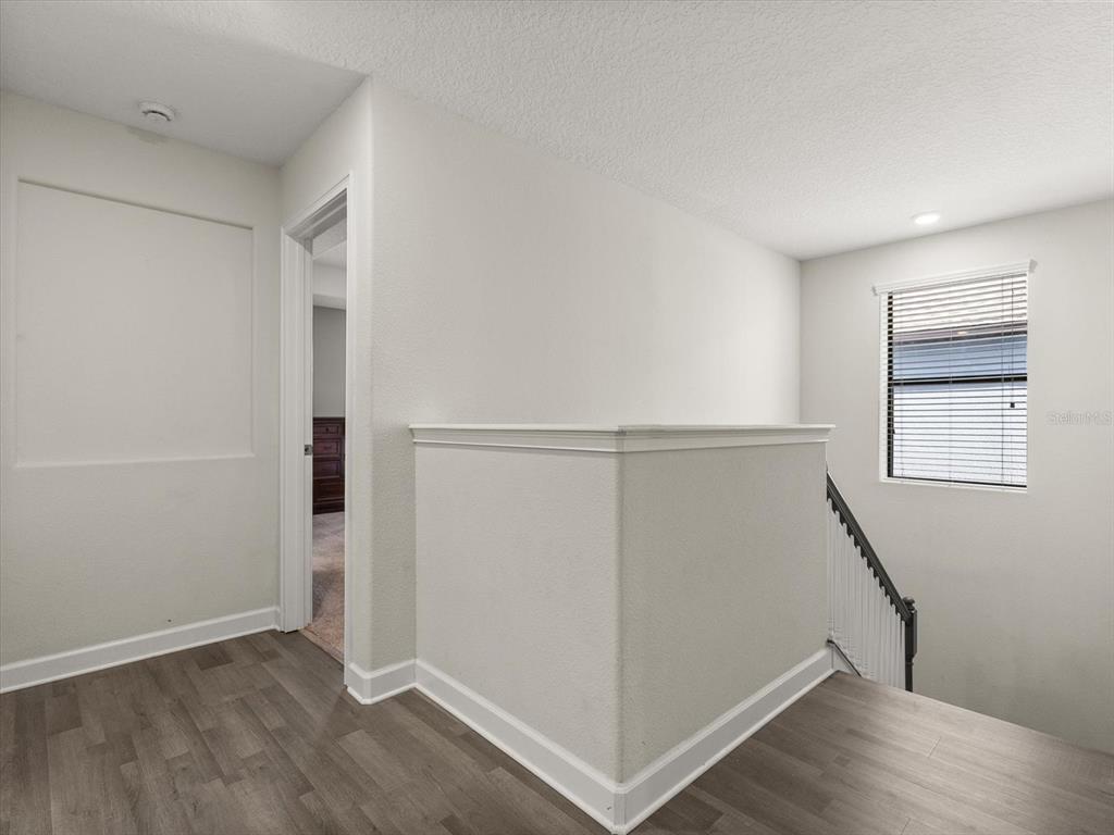 15433 Porter Road Winter Garden, FL 34787 - Photo 37 of 46 an empty room with wooden floor and windows