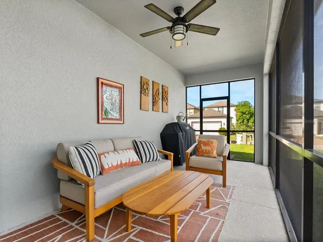 a bedroom with furniture and a large window
