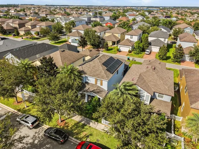 an aerial view of residential houses with outdoor space