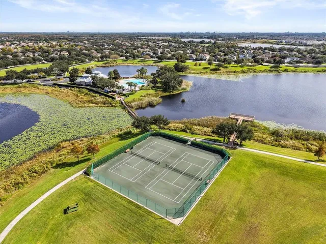 an aerial view of a residential building and lake view