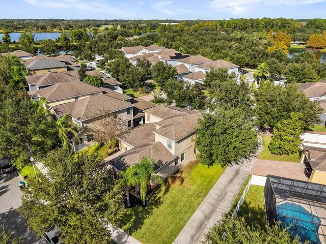 an aerial view of residential houses with outdoor space