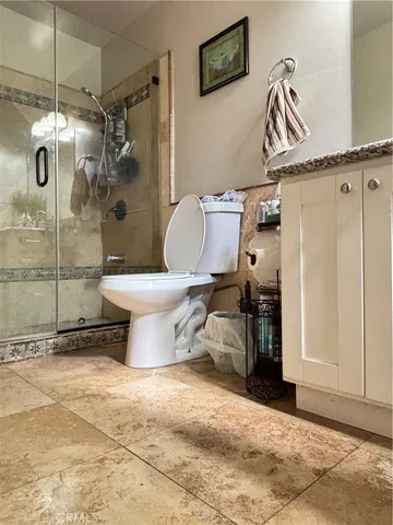 a bathroom with a toilet sink and shower