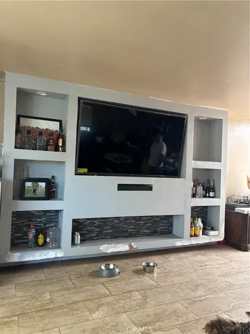 a living room with painting and a flat screen tv