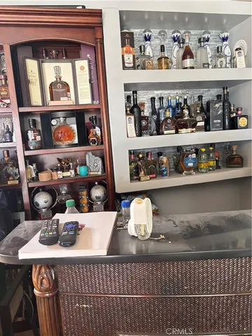 a table with wine bottles and glasses on it