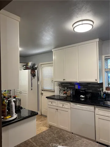 a kitchen with refrigerator and cabinets