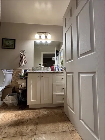 a view of a bathroom with mirror and sink