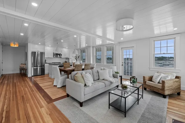 a living room with furniture and kitchen view