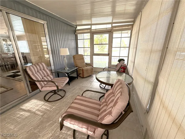a living room with furniture and floor to ceiling windows