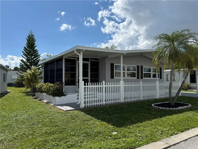 a view of a house with a small yard and plants